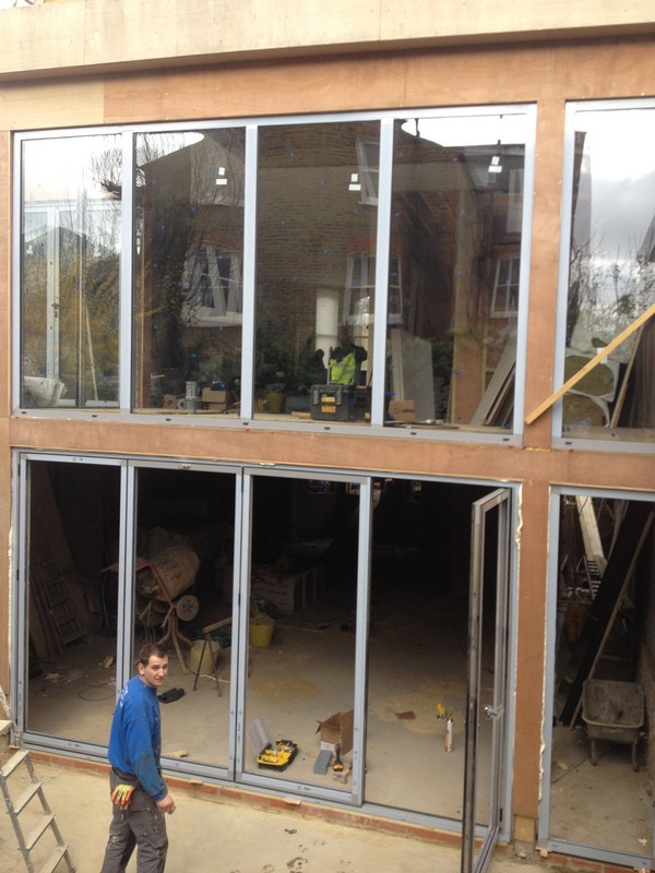 Aluminium bi-fold doors with two-storey glazing in Lower Edmonton