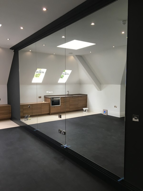 Frameless glass partition in loft conversion by Lower Edmonton glaziers